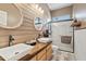 Farmhouse-style bathroom with dual sinks, butcherblock vanity, and a modern shower at 3095 E Cardinal Ct, Chandler, AZ 85286