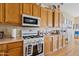 Well-equipped kitchen with wood cabinets, a center island, and white appliances for a functional cooking space at 3095 E Cardinal Ct, Chandler, AZ 85286