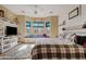 Inviting main bedroom with a bay window seating area, wood-look accents, and TV console at 3095 E Cardinal Ct, Chandler, AZ 85286