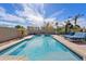 Resort-style pool with a waterfall feature, lounge seating, and lush tropical landscaping at 3095 E Cardinal Ct, Chandler, AZ 85286