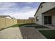 Serene backyard with artificial grass, stone pavers, and a sturdy block wall for privacy at 35378 W Santa Barbara Ave, Maricopa, AZ 85138