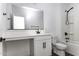 Modern bathroom featuring a vanity with a white countertop, a large mirror, and a shower-tub combo at 35378 W Santa Barbara Ave, Maricopa, AZ 85138