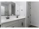 Modern bathroom with double vanity, sleek black fixtures, and a large mirror at 35378 W Santa Barbara Ave, Maricopa, AZ 85138