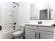 Bathroom showcasing a white vanity and a shower-tub combo at 35378 W Santa Barbara Ave, Maricopa, AZ 85138