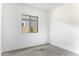 A simple bedroom with carpet and a view from the window at 35378 W Santa Barbara Ave, Maricopa, AZ 85138