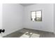 Bright bedroom with carpet flooring, white walls and trim, and a window overlooking the backyard at 35378 W Santa Barbara Ave, Maricopa, AZ 85138