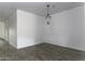 The Dining Room has grey wood-look flooring with a pendant light fixture at 35378 W Santa Barbara Ave, Maricopa, AZ 85138