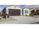 Charming single-story home with a brown garage door, blue accents, and desert landscaping at 35378 W Santa Barbara Ave, Maricopa, AZ 85138