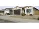 Charming single-story home with a brown garage door, blue accents, and desert landscaping at 35378 W Santa Barbara Ave, Maricopa, AZ 85138