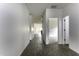 Long hallway featuring wood-look tile flooring, white walls and trim, and recessed lighting at 35378 W Santa Barbara Ave, Maricopa, AZ 85138