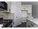 Close up of the kitchen showing white cabinets and tile backsplash at 35378 W Santa Barbara Ave, Maricopa, AZ 85138