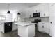 Kitchen featuring white cabinets and a center island with a sink at 35378 W Santa Barbara Ave, Maricopa, AZ 85138