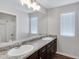 Bathroom featuring double sinks, large mirror, and window at 38179 W La Paz St, Maricopa, AZ 85138