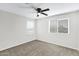 Neutral bedroom featuring a ceiling fan, carpeted flooring, and natural light at 38179 W La Paz St, Maricopa, AZ 85138