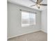 Bright bedroom with neutral walls, ceiling fan, carpet, and window with blinds at 38179 W La Paz St, Maricopa, AZ 85138