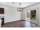 Dining room with wood floors, modern light fixture, and sliding glass doors to the backyard at 38179 W La Paz St, Maricopa, AZ 85138