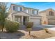 Charming two-story home with a well-kept yard, featuring desert landscaping and a two-car garage at 38179 W La Paz St, Maricopa, AZ 85138