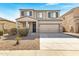 Charming two-story home with a two-car garage, neutral-colored facade, and low-maintenance landscaping at 38179 W La Paz St, Maricopa, AZ 85138