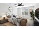 Bedroom featuring a tufted headboard, ceiling fan, and natural light at 38179 W La Paz St, Maricopa, AZ 85138