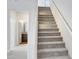 Carpeted staircase leading to the second floor with a partial view of the bathroom at 38179 W La Paz St, Maricopa, AZ 85138