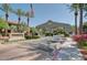 Welcoming entrance with lush landscaping and monument sign at Portofino Condominiums under a clear blue sky at 3830 E Lakewood E Pkwy # 3014, Phoenix, AZ 85048