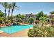 Relaxing community pool surrounded by palm trees, lounge chairs, and beautiful landscaping at 3830 E Lakewood E Pkwy # 3014, Phoenix, AZ 85048