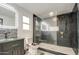 Sleek bathroom featuring modern fixtures, a glass-enclosed shower, and a stylish vanity with stone accents at 3915 E Hillery Dr, Phoenix, AZ 85032