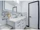 Bright bathroom featuring a sleek vanity, modern fixtures, decorative tile, and a framed mirror at 3915 E Hillery Dr, Phoenix, AZ 85032