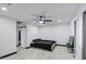 Spacious bedroom featuring a modern ceiling fan, ample lighting, and minimalist decor at 3915 E Hillery Dr, Phoenix, AZ 85032