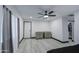 Bedroom with a modern ceiling fan, neutral colored walls, and an open closet space with a sliding barn door at 3915 E Hillery Dr, Phoenix, AZ 85032