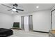 A bedroom with minimalist decor featuring neutral colored walls, a modern ceiling fan, and hardwood floors at 3915 E Hillery Dr, Phoenix, AZ 85032