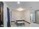 Dining area featuring a marble top table, white chairs, and modern light fixture at 3915 E Hillery Dr, Phoenix, AZ 85032