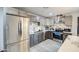 A spacious kitchen with stainless steel refrigerator, granite countertops, and two-tone cabinetry at 3915 E Hillery Dr, Phoenix, AZ 85032