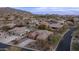 Beautiful twilight aerial shot showcasing neighborhood and mountains, desert landscaping, and single Gathering homes at 4109 N Twilight Cir, Mesa, AZ 85207