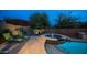 Tranquil backyard spa area with lounge chairs and desert plants under the evening sky at 4109 N Twilight Cir, Mesa, AZ 85207