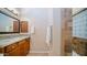 Bathroom vanity with granite countertop and tiled shower at 4109 N Twilight Cir, Mesa, AZ 85207