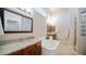 Bright bathroom with large mirror, granite countertop, and a soaking tub at 4109 N Twilight Cir, Mesa, AZ 85207