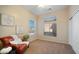 Cozy bedroom with neutral colors and a comfortable chair by the bright window at 4109 N Twilight Cir, Mesa, AZ 85207