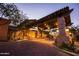 Grand entrance featuring a stone-covered portico, porte cochere and intricate architectural details at dusk at 4109 N Twilight Cir, Mesa, AZ 85207