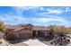 Stunning home featuring a three car garage, desert landscaping, and a tile roof set against a beautiful blue sky at 4109 N Twilight Cir, Mesa, AZ 85207