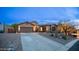 Beautiful home featuring a spacious driveway, three-car garage and desert landscaping at twilight at 4109 N Twilight Cir, Mesa, AZ 85207