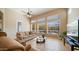 Cozy living room with large windows, comfortable seating, and a ceiling fan for added comfort at 4109 N Twilight Cir, Mesa, AZ 85207