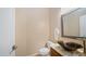 Stylish powder room features an artistic vessel sink with a granite countertop and modern fixtures at 4109 N Twilight Cir, Mesa, AZ 85207