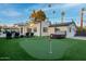 Spacious backyard with putting green, hot tub, lounge seating, and manicured turf at 4132 N 34Th Pl, Phoenix, AZ 85018