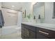 Modern bathroom features sleek vanity, gold hardware, and tiled shower at 4132 N 34Th Pl, Phoenix, AZ 85018