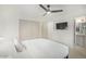 Modern bedroom with large TV, ceiling fan, and ensuite bathroom access at 4132 N 34Th Pl, Phoenix, AZ 85018