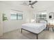 Bright, minimalist bedroom featuring a queen bed, modern ceiling fan and light-filled windows at 4132 N 34Th Pl, Phoenix, AZ 85018