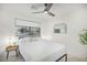 Modern bedroom with a ceiling fan, window, and neutral decor create a comfortable and relaxing atmosphere at 4132 N 34Th Pl, Phoenix, AZ 85018