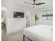 Bright bedroom featuring a sleek ceiling fan, a large TV, and ensuite bathroom access at 4132 N 34Th Pl, Phoenix, AZ 85018