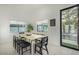 Bright dining area showcasing modern furniture, ample natural light, and a view of the sparkling pool at 4132 N 34Th Pl, Phoenix, AZ 85018